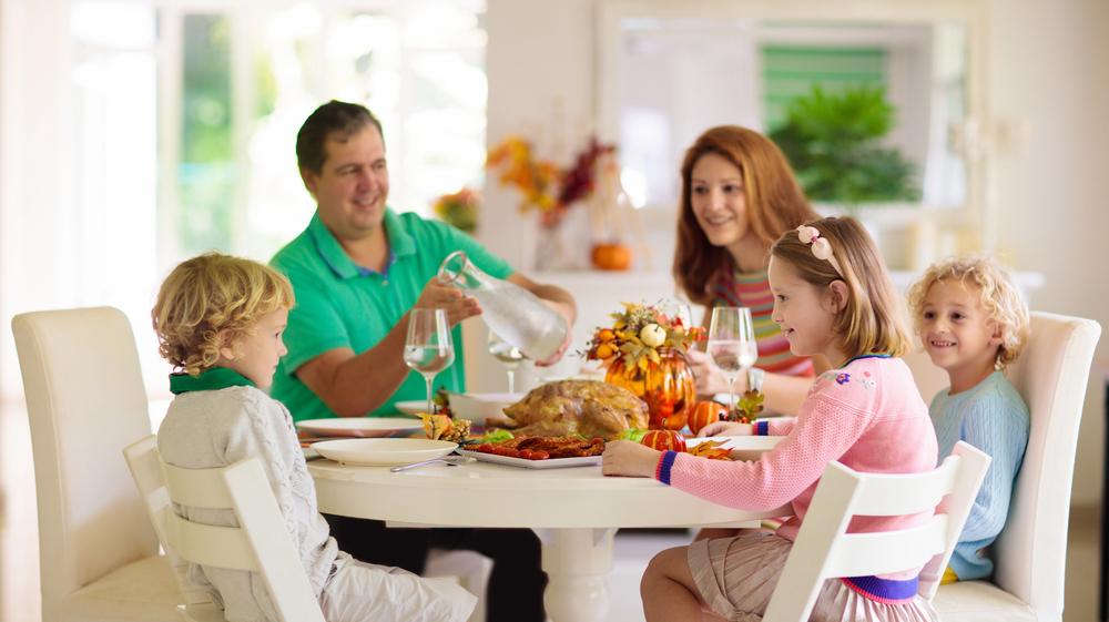 Family with kids at Thanksgiving dinner Family with kids at Thanksgiving dinner