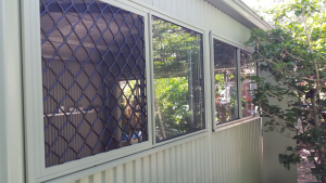 shed windows with screen installed on a steel shed