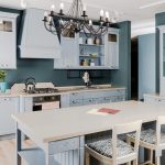 Interior of modern light kitchen with white wooden furniture