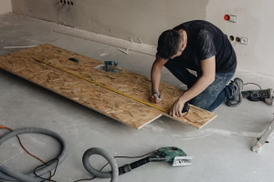 man measuring the wood