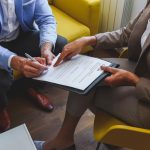 Happy couple signing papers