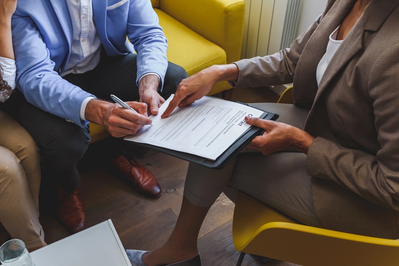 Happy couple signing papers Happy couple signing papers