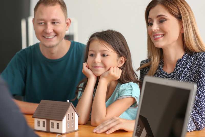 Happy family with real estate agent in office Happy family with real estate agent in office