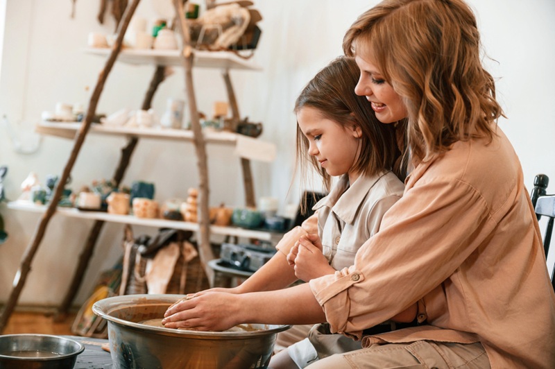Sitting together. Mother with little girl doing pottery at home. Sitting together. Mother with little girl doing pottery at home.
