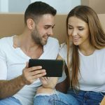 man and woman excited to buy a house