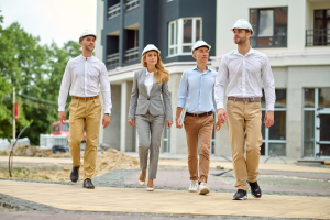 people walking on construction site with helments on