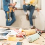 Close-up view of tools and digital devices on table during house renovation