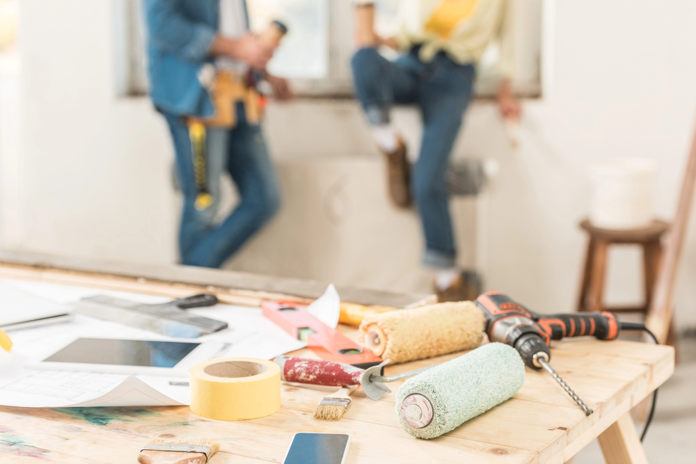 Close-up view of tools and digital devices on table during house renovation