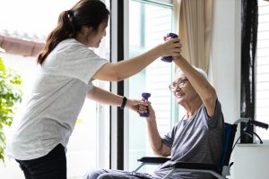 Female physiotherapist working or work out with a senior patient