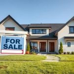 house on sale with sign at front