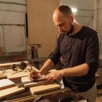 man doing woodwork in his workshop