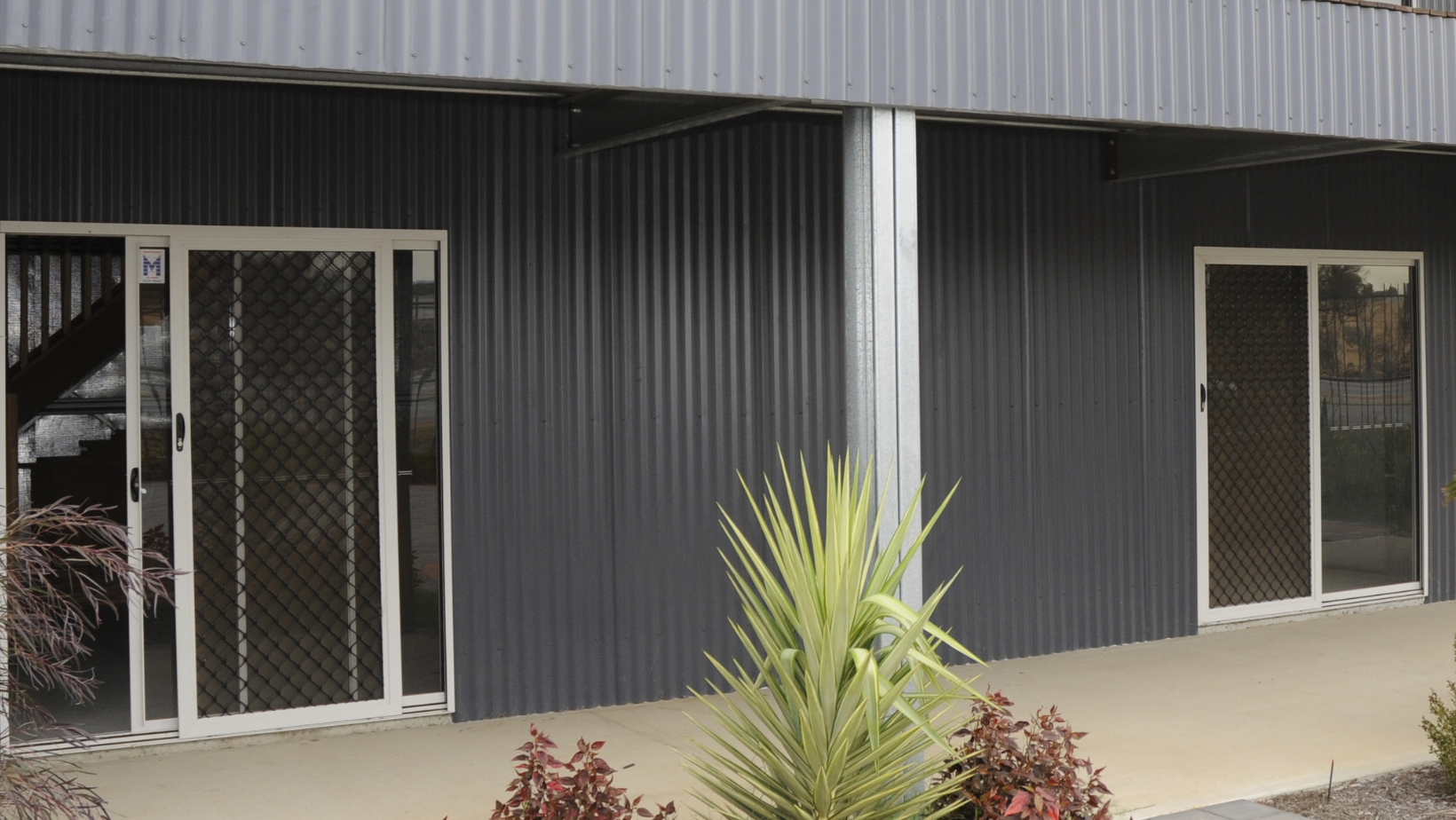steel shed with 2 sliding glass doors with screen