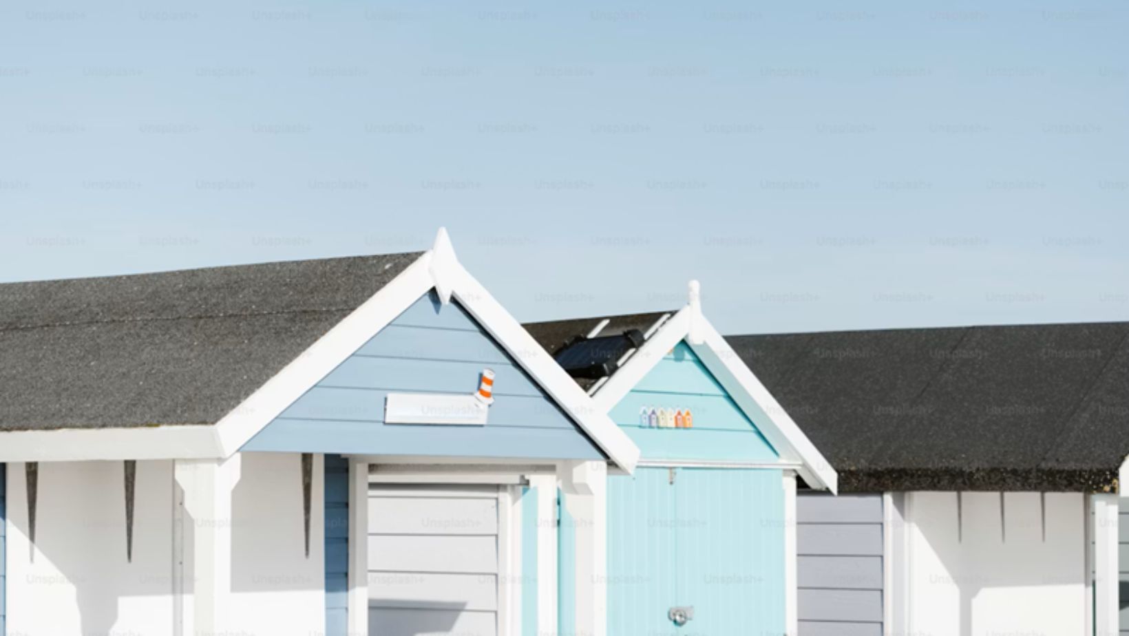 A row of beach huts sitting next to each other