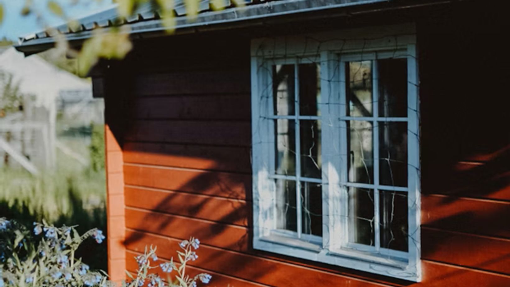 A small red house with a white window