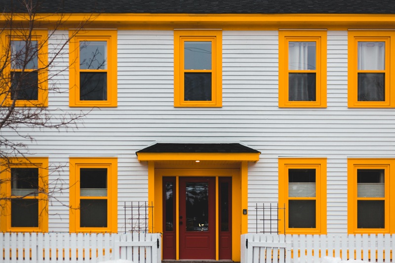 Red Wooden Door on White Wooden House
