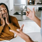 Black couple arguing with each other at home