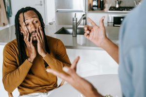 Black couple arguing with each other at home