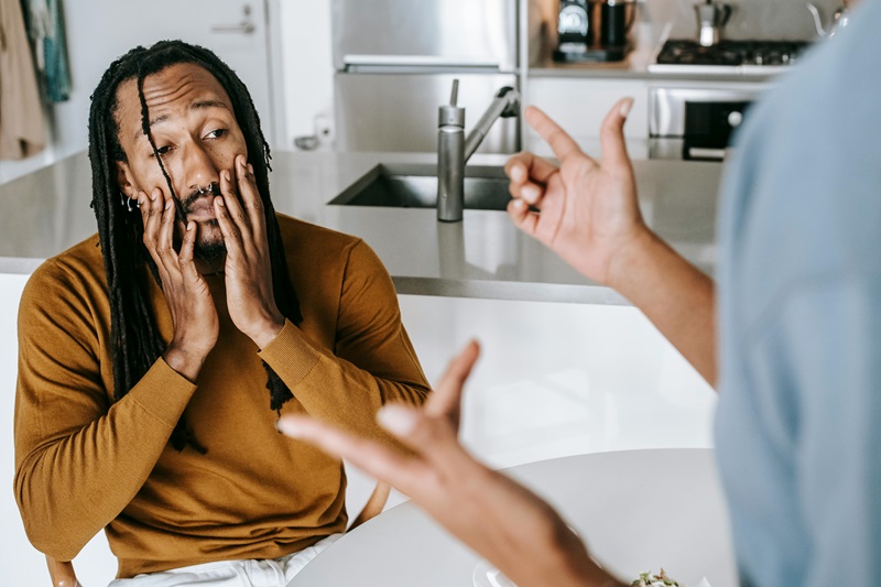 Black couple arguing with each other at home