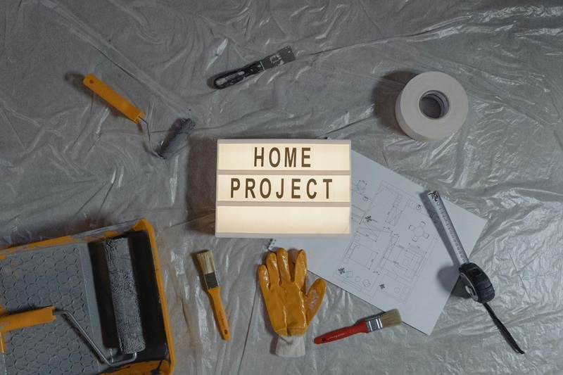 Home renovation tools and floor plans surrounding a HOME PROJECT lightbox