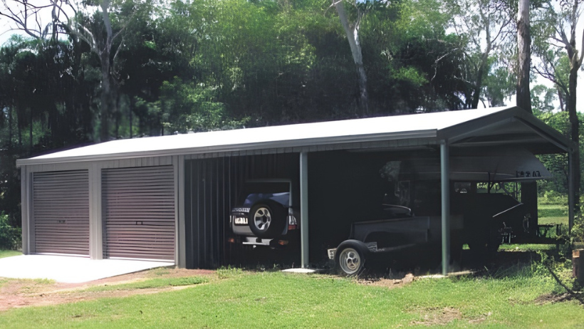 Large steel shed in Australia with garage doors and open carport section, used for vehicle storage in a rural setting