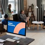 People Having a Meeting Near the Computer on the Table