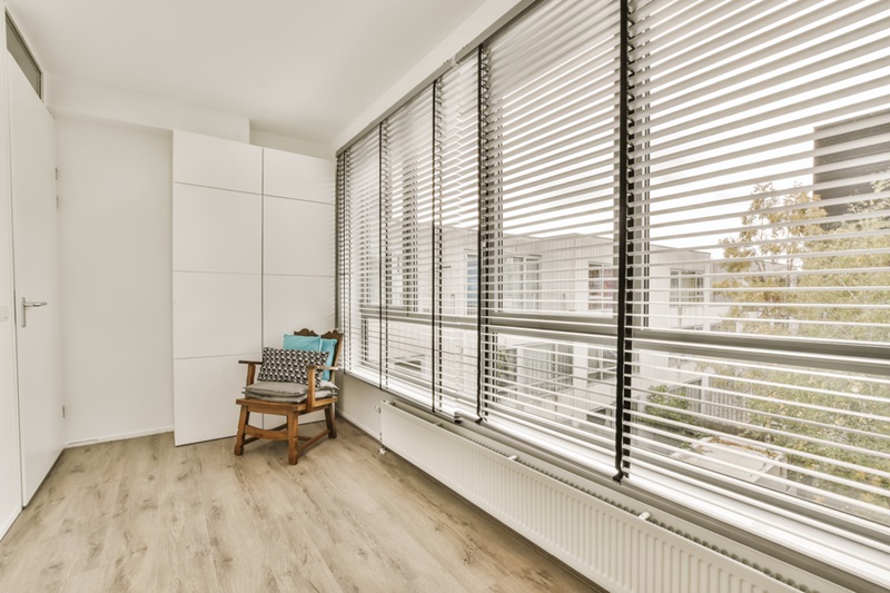 Room with white flooring and window shutters