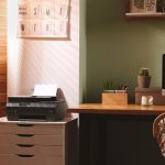 Stylish workplace with computer printer and houseplant