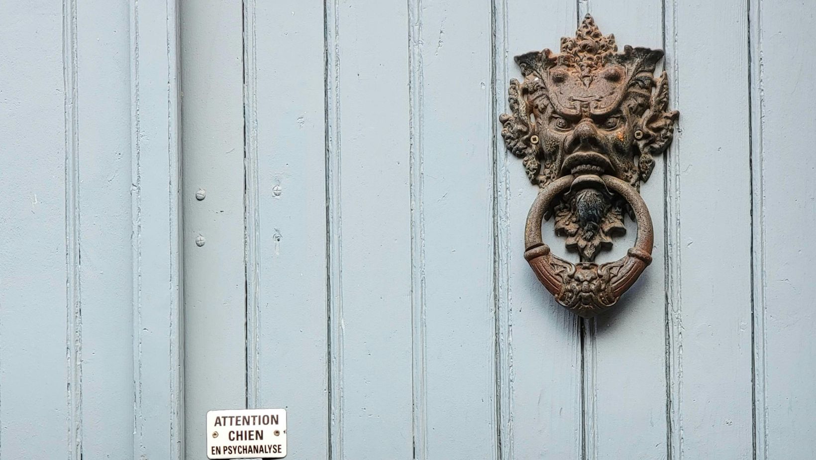 Vintage Wooden Door with Ornate Key and Knocker