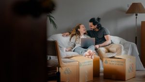 A young couple takes a break from unpacking