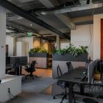 Contemporary office space with desks and plants in Amsterdam