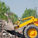 Excavator working with brick debris