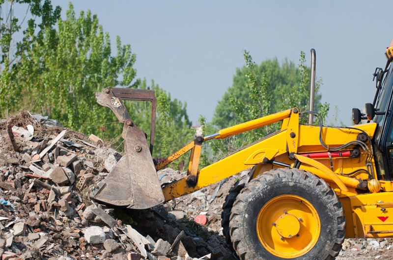 Excavator working with brick debris