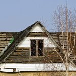 Old wooden loft with windows against the blue sky