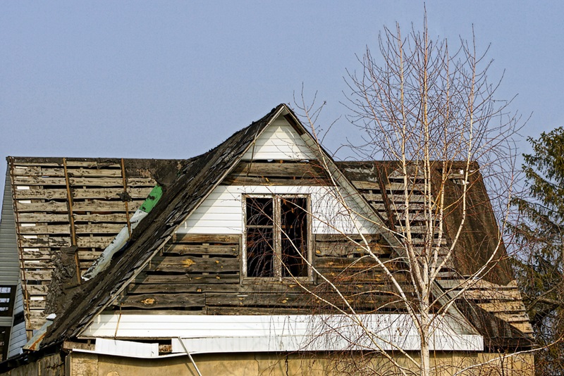 Old wooden loft with windows against the blue sky Old wooden loft with windows against the blue sky