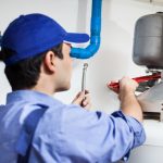 Professional Plumber Repairing a Hot Water System