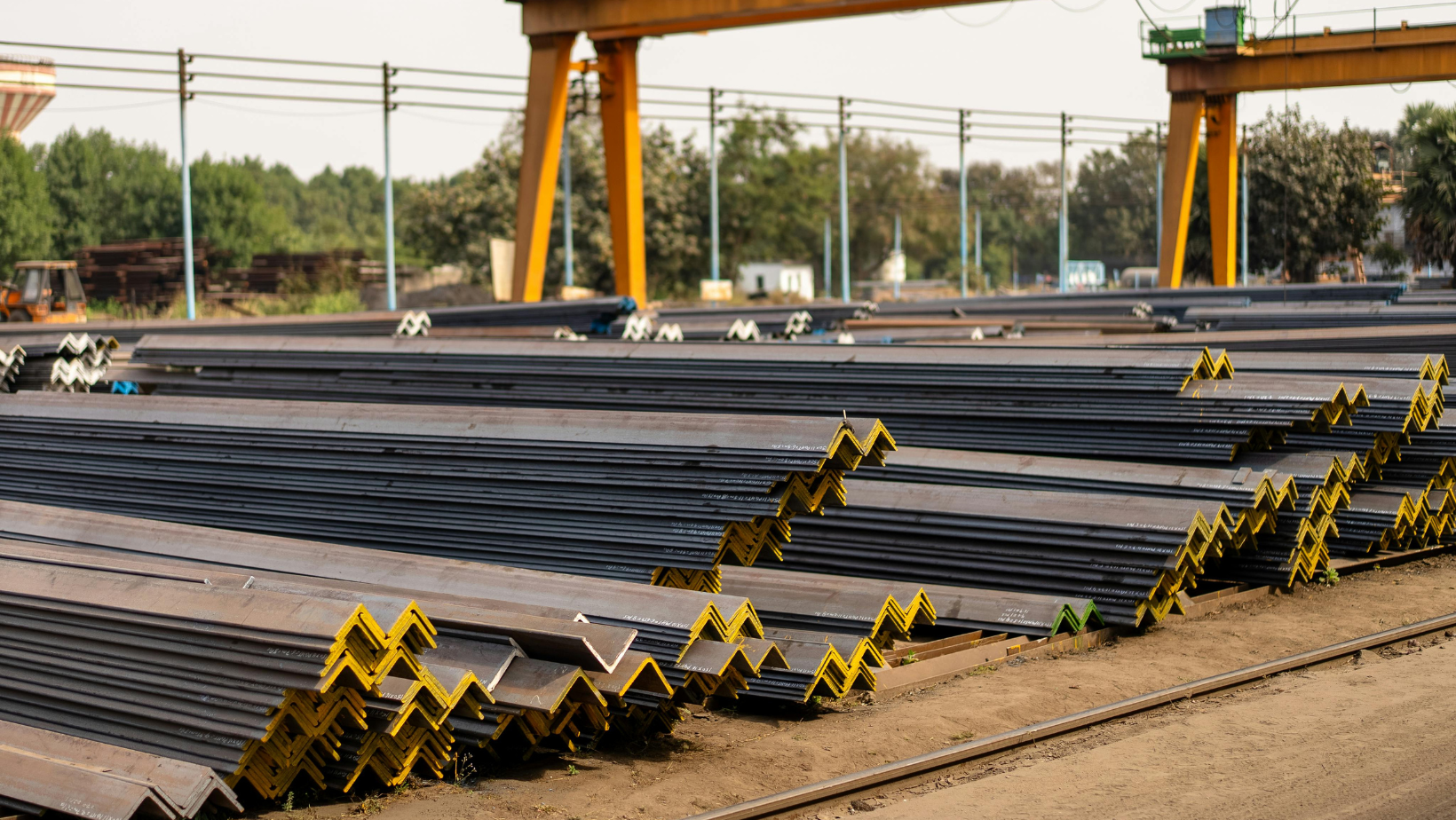 Stacked Steel Beams in Industrial Yard