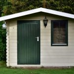 cream-colored garden shed or small cabin