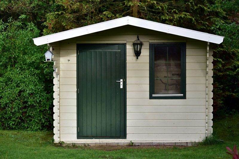 cream-colored garden shed or small cabin