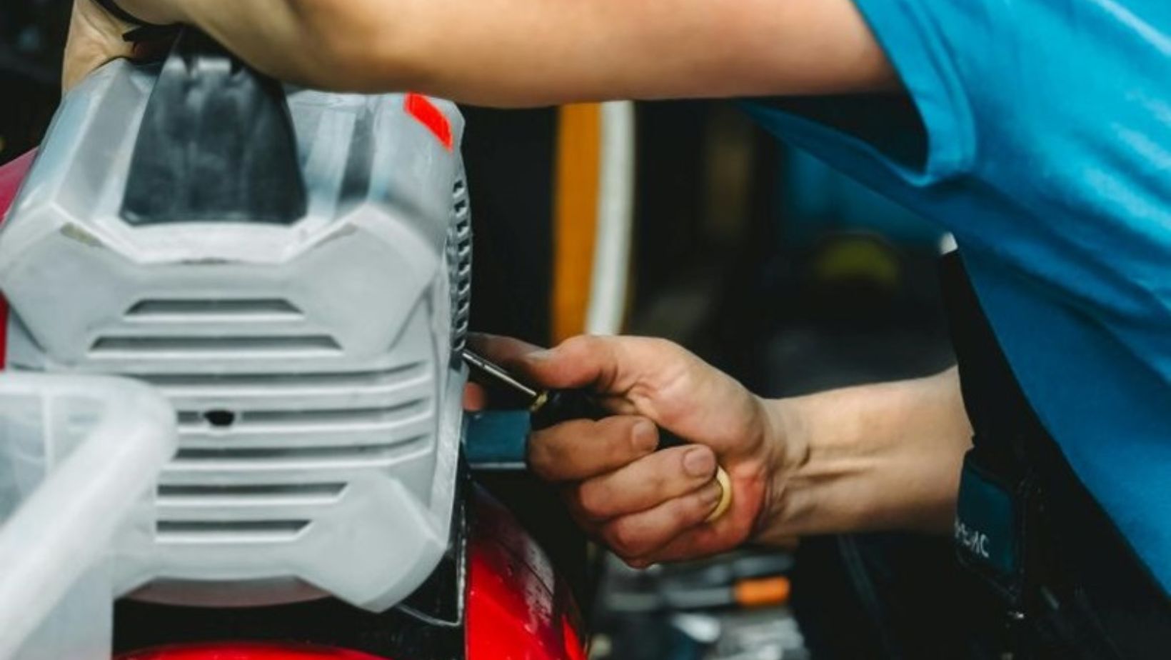 technician performing maintenance on a portable air compressor
