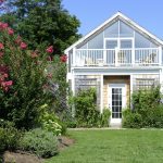 A white house with a porch and a deck