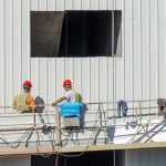Construction lifting platform elevate builders at wall
