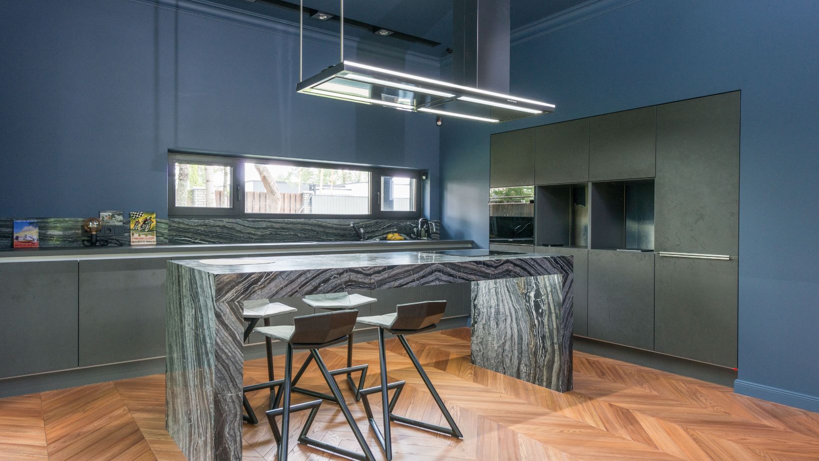 Contemporary blue kitchen featuring a sleek granite island and modern decor