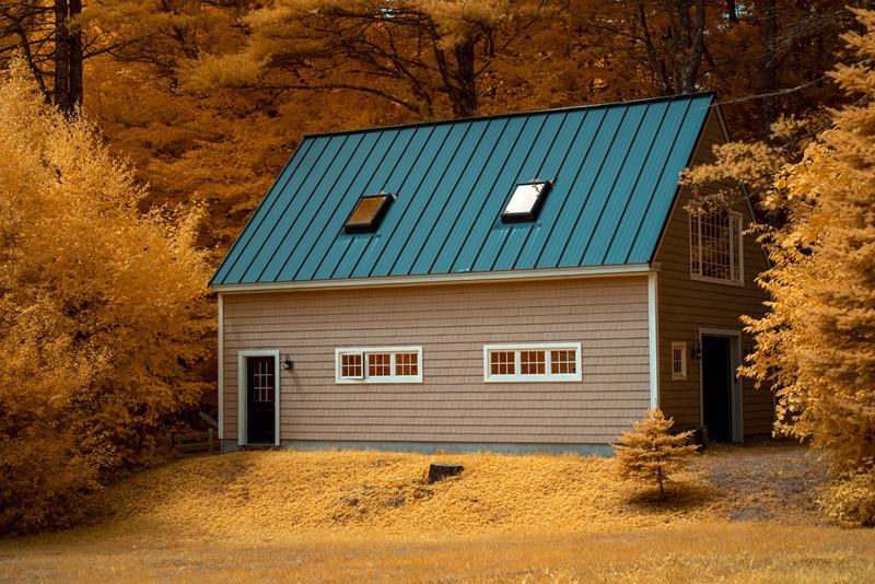 Cozy country house amidst vibrant fall foliage creates a warm, inviting scene