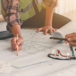 Hands on blueprint construction site