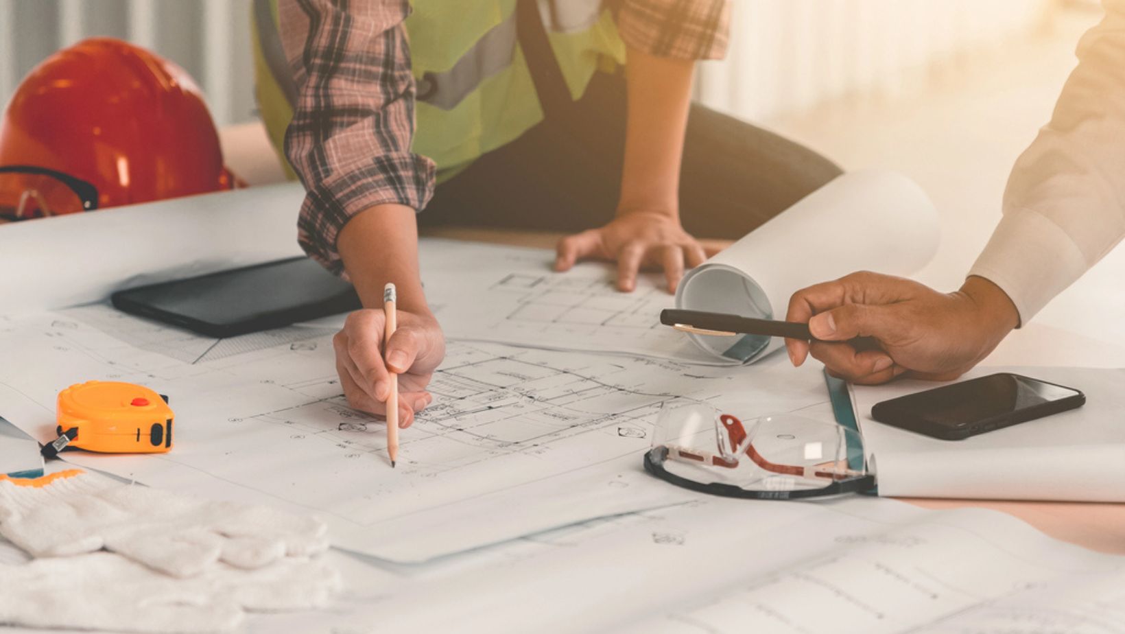 Hands on blueprint construction site