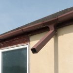 brown steel gutter on garage