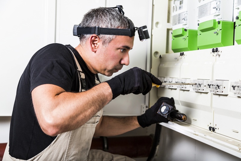 Electrician repairs and measures fuse box or switch box Electrician repairs and measures fuse box or switch box
