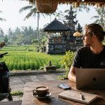 Freelancer with Laptop Overlooking Scenic Rice Terraces