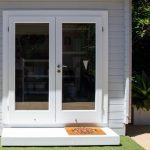 Modern White French Doors on a Grey Backyard Studio