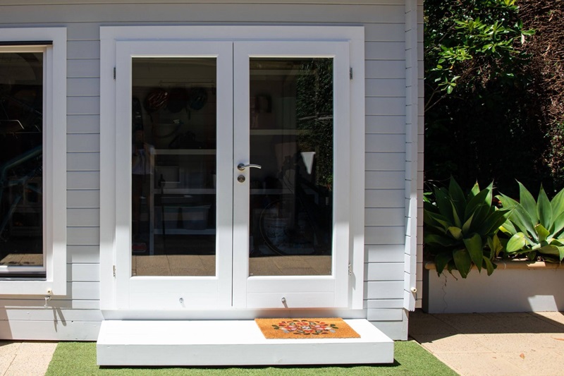 Modern White French Doors on a Grey Backyard Studio Modern White French Doors on a Grey Backyard Studio